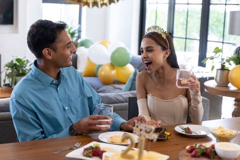Joyful Couple Celebrating Birthday with Toast and Conversation