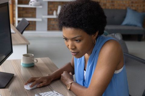 Focused Professional Woman Typing at Office Desk