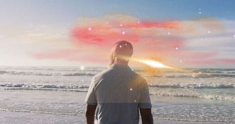 Man Watching Tranquil Ocean Sunset with Cosmic Overlay