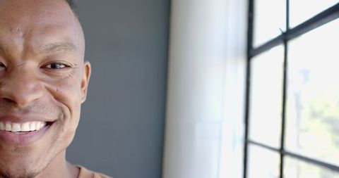 Smiling Professional Enjoying Natural Light Near Office Window