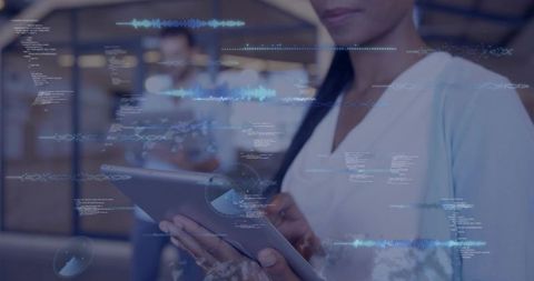 Businesswoman using tablet with holographic analytics overlays in coworking workspace