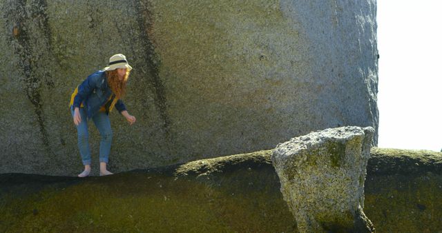 Young Woman Balancing on Rock Formation with Sun Hat - Download Free Stock Images Pikwizard.com