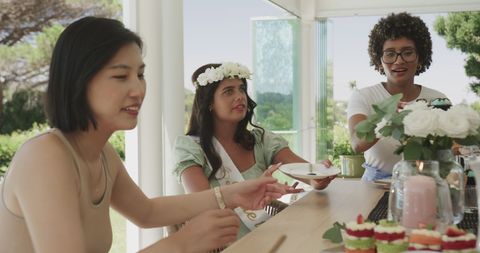 Diverse women enjoying a bridal shower with tea and conversation