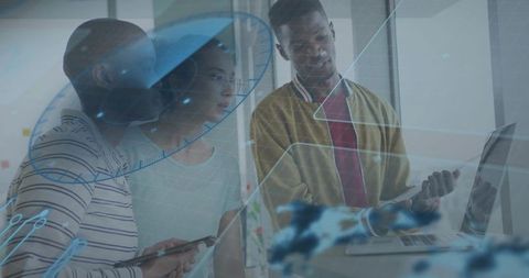 Diverse team collaborating on laptop and tablet with augmented reality overlays