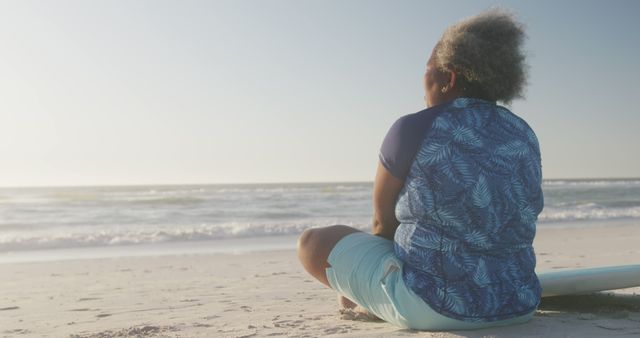 Senior Woman Relaxing on Sandy Beach at Sunset - Download Free Stock Images Pikwizard.com