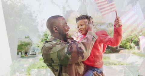 Joyful African American Father Raising Son on Patriotic Day