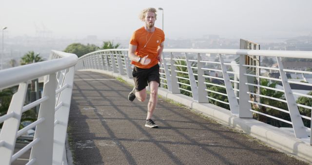 Young Man Jogging on Urban Bridge in Morning Light - Download Free Stock Images Pikwizard.com