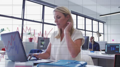 Focused Businesswoman Analyzing Financial Data at Office Desk