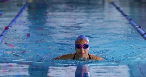 Focused athlete swimming in pool lane with determination