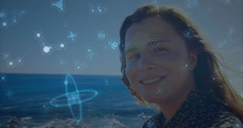 Woman by sea with futuristic dna holograms