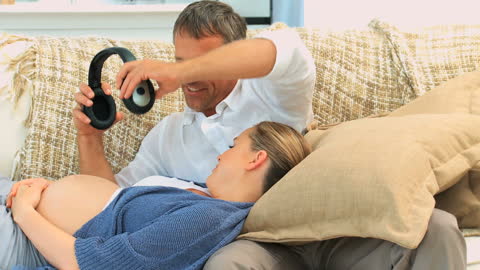 Expecting Couple Connecting with Unborn Baby Using Music