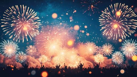 Vibrant Fireworks Exploding Over Celebratory Crowd