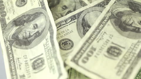 Spinning US Dollar Bills in Motion for Financial Concepts