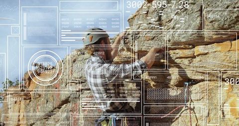 Rock climber scaling cliff with augmented reality data interface