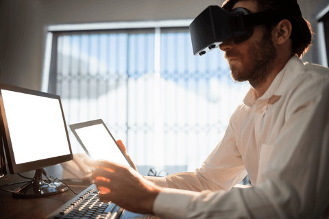 Businessman with transparent virtual reality device in modern office