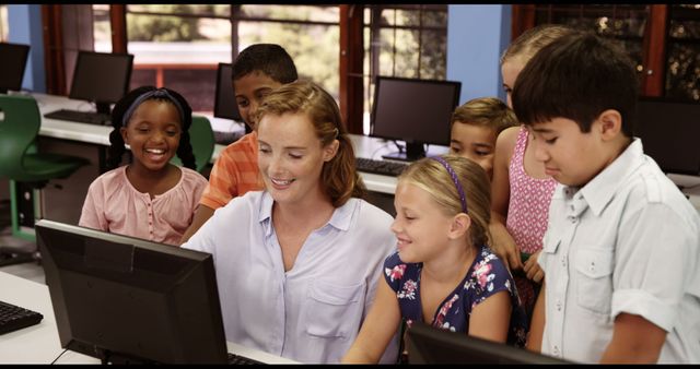 Happy Teacher Assisting Diverse Group of Students on Computers in Classroom - Download Free Stock Images Pikwizard.com