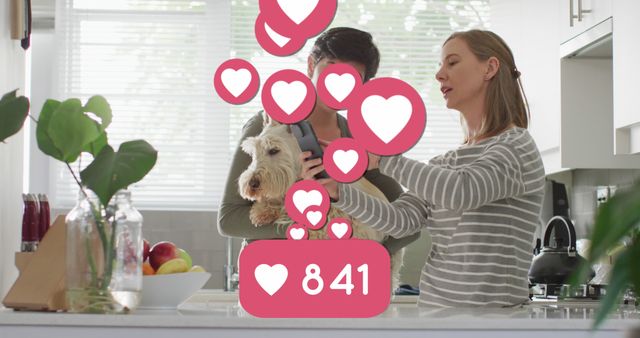 Image of heart emojis and numbers over happy caucasian female couple in love. Love, romance and celebration concept digitally generated image.