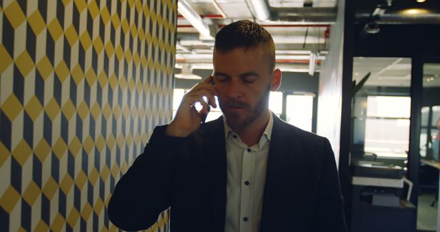 Businessman Walking in Office Hallway Talking on Smartphone - Download Free Stock Images Pikwizard.com