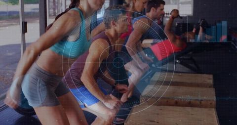 Group performing box step-ups for plyometric fitness training in gym class