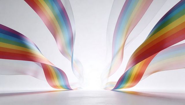 Ethereal flowing rainbow ribbons converging on luminous center in minimalist high-key scene