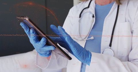 Doctor in White Coat Using Tablet in Modern Healthcare Setting