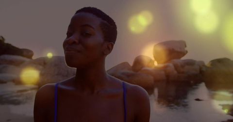 Woman in swimsuit embracing serenity by calm coastal water