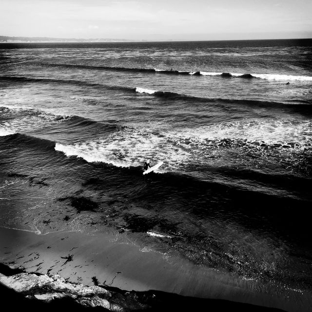 Surfer Riding Calm Ocean Waves in Black and White - Download Free Stock Photos Pikwizard.com