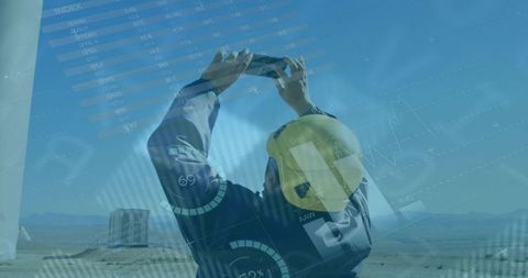 Technician Using Tablet for Wind Turbine Inspection under Clear Blue Sky