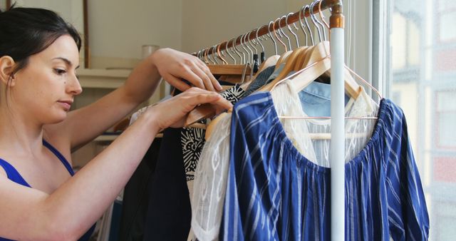 Woman Organizing Clothes on Rack at Home - Download Free Stock Images Pikwizard.com