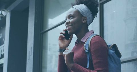 Woman with Smartphone Standing Urban Street Wearing Headband