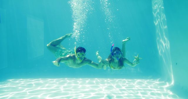 Couple Snorkeling Underwater in Pool Enjoying Summer - Download Free Stock Images Pikwizard.com