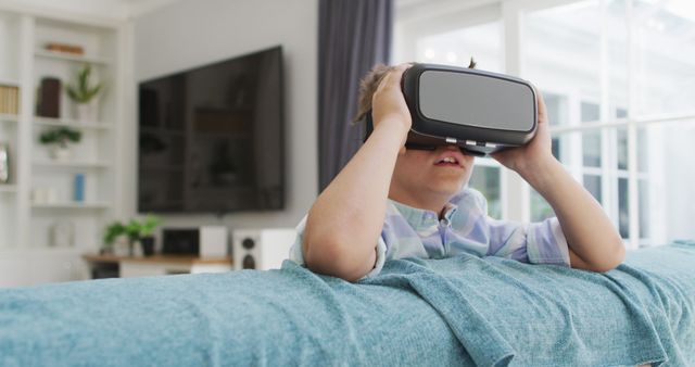 Young boy exploring virtual reality at home - Download Free Stock Images Pikwizard.com