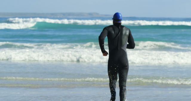 Surfer Running into Sea Wearing Wetsuit - Download Free Stock Images Pikwizard.com