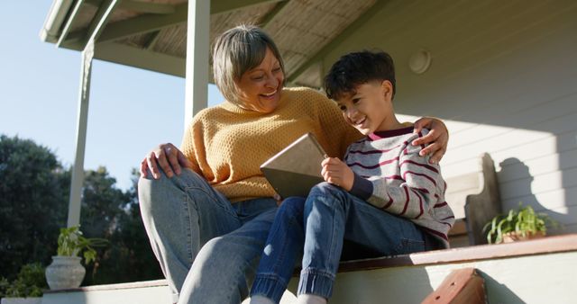 Grandmother and Grandson Using Tablet on Porch - Download Free Stock Images Pikwizard.com