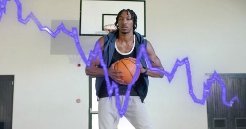 Basketball Player Holding Ball on Indoor Court with Purple Waveform Overlay Showing Stats