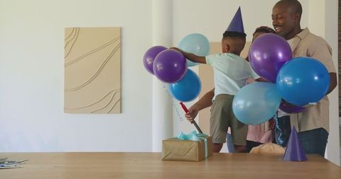 Joyful Family Birthday Celebration with Balloons and Gifts