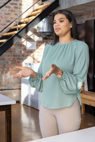 Confident woman in modern coworking space giving presentation