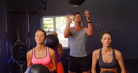 Group Fitness Class Exercising with Medicine Balls in Gym - Download Free Stock Images Pikwizard.com