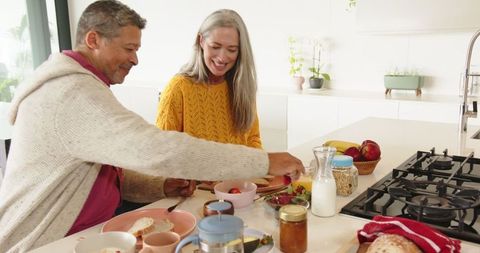 Diverse Couple Enjoying Healthy Breakfast in Modern Kitchen