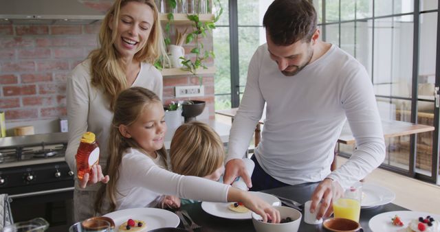 Happy Family Making Breakfast Together in Modern Kitchen - Download Free Stock Images Pikwizard.com