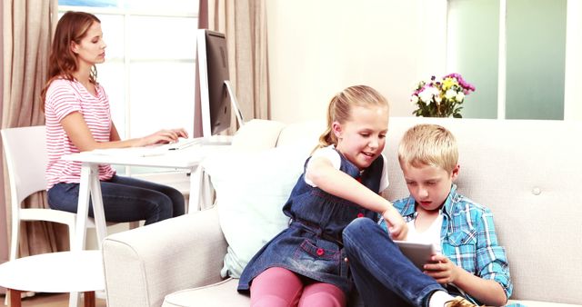 Children Playing on Tablet While Mother Works Remotely at Home - Download Free Stock Images Pikwizard.com