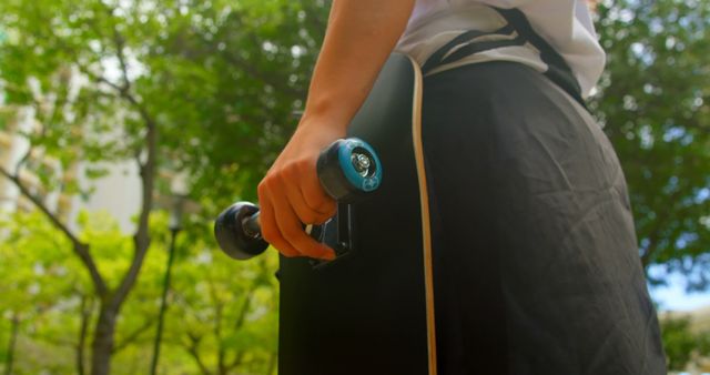 Teen Holding Skateboard in Warm Sunlight - Download Free Stock Images Pikwizard.com