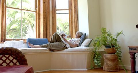 Senior Woman Reading Book by Sunlit Window in Cozy Home - Download Free Stock Images Pikwizard.com