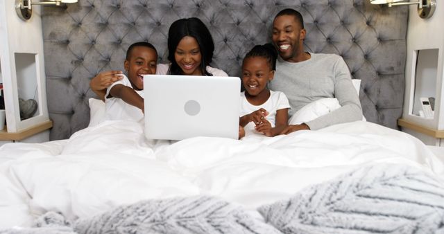 Happy African American Family Enjoying Time Together on Bed with Laptop - Download Free Stock Images Pikwizard.com