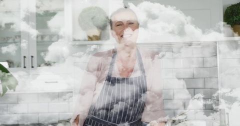 Smiling home cook enjoying cloudy sky in rustic kitchen