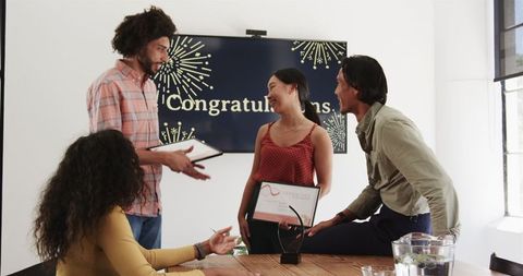 Diverse colleagues celebrating workplace achievements and team success