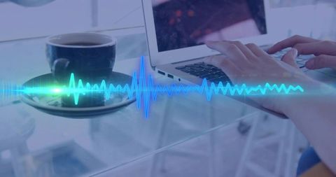 Typing hands with glowing audio waveform over laptop and coffee on glass desk