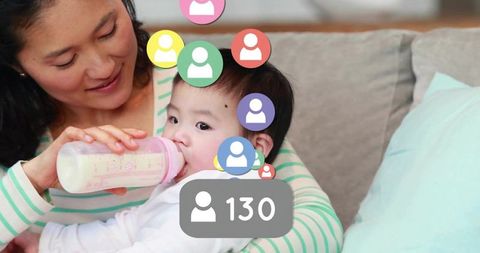 Father Feeding Baby with Bottle and Social Media Influence Concept