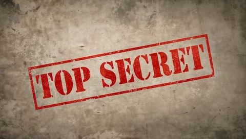 Red top secret stamp on aged paper vintage grunge background diagonal classified document