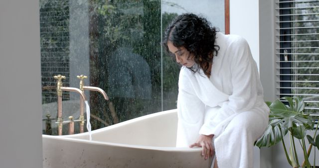 Woman Adjusting Water Temperature in Luxurious Bathtub by Rainy Window - Download Free Stock Images Pikwizard.com